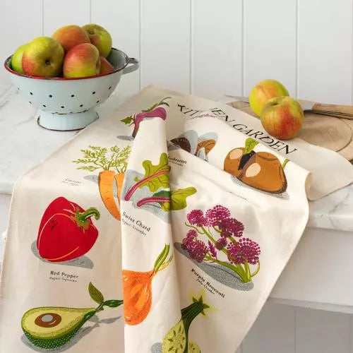 Kitchen Garden Tea Towel draped over kitchen counter next to a colander of washed apples.