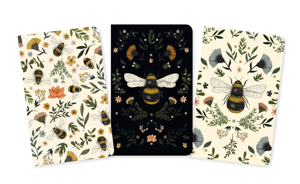 Three notebooks with bee and floral designs on a white background