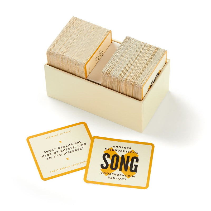 Set of playing cards in a cardboard box with two cards displayed on a white background