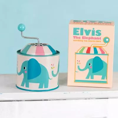 Elvis The Elephant musical box next to its packaging. Both have a big blue elephant on. 